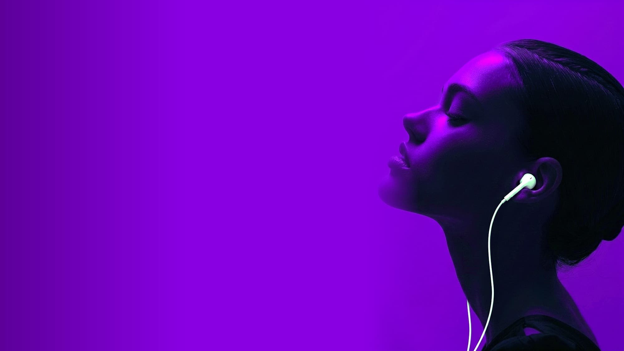 A woman in profile, eyes closed, lost in her music under electric-violet light — a single wired earphone, deep negative space to her left.